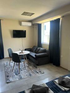 a living room with a couch and a table at Стаи за гости Крис in Vratsa