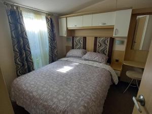 a bedroom with a bed in a small room at Emma 6 in Menai Bridge