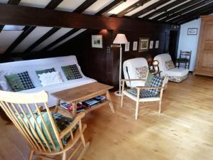a living room with chairs and a bed and a table at Central Location Cozy 3 BR Flat in Gstaad in Gstaad