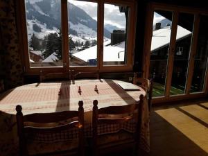 a table in a room with a view of a mountain at Central Location Cozy 3 BR Flat in Gstaad in Gstaad