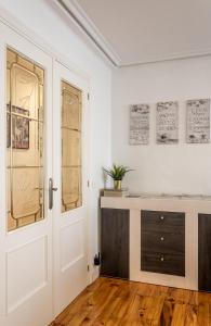 Habitación blanca con escritorio y puerta en Apartamento Saioa, en Pamplona