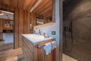 a bathroom with a sink and a shower at Mountainlodge Luxalpine in San Vigilio Di Marebbe +195 photos