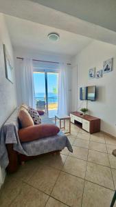 a bedroom with a bed and a view of the ocean at Apartmani Vinka in Pisak +46 photos