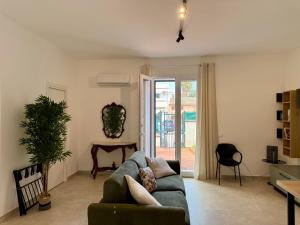a living room with a couch and a table at Casa Baglio Monti in Palermo