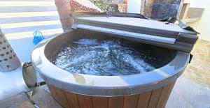 a bucket of water sitting on a porch at Villa Elia Blue , hot tube , heated pool in Paralimni
