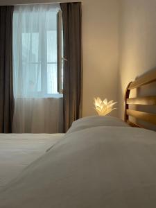 a bedroom with a white bed and a window at Apartments Goldie in Senj