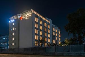 a hotel building with a sign on it at night at TGI Livancia The Sojourn in Bengaluru