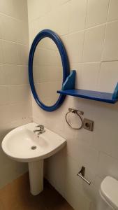 a bathroom with a sink and a mirror on the wall at Larimar in Almería +12 photos