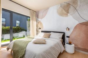 a bedroom with a bed and a large window at Villa Mol by Villsy - with private pool, sauna, jacuzzi in Baderna +54 photos