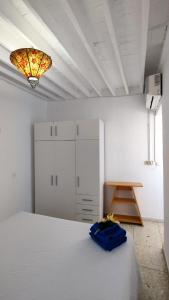 a bedroom with a bed and a light on the ceiling at Larimar in Almería