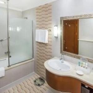 a bathroom with a sink and a shower and a mirror at Holiday International Hotel Embassy District by CMG in Dubai
