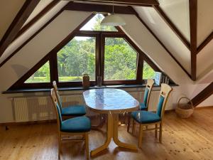 a dining room with a table and four chairs at Ferienhaus Knappensee in Lohsa