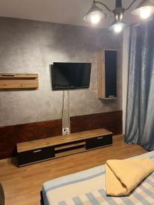 a living room with a flat screen tv on the wall at Sand and Waves House in Constanţa