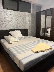 a large bed in a bedroom with a mirror at Sand and Waves House in Constanţa
