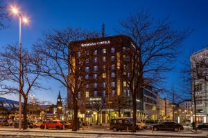 a tall building in a city at night at Generator Hamburg in Hamburg