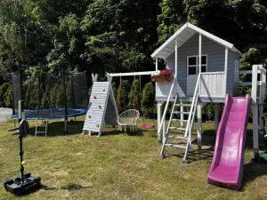a playground with a play house and a slide at Pokoje Gościnne Ontario Mieroszyno in Jastrzębia Góra