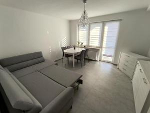 a living room with a couch and a table at apartament przy cukierni in Knurów