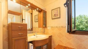 a small bathroom with a sink and a mirror at FINCA LA GRANDA DE LA CONCHA in Nueva de Llanes +44 photos