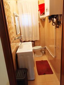 a small bathroom with a toilet and a sink at Nonno Nanni casa vacanze in Portocannone +22 photos