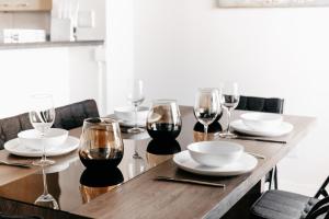 a wooden table with glasses of wine on it at Opulent Heights- Westpoint Sandton in Johannesburg