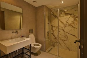 a bathroom with a toilet and a sink and a shower at Mandala Karaköy Hotel in Istanbul +17 photos