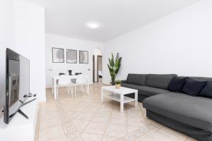 a living room with a couch and a table at Home2Book Luxury Villa Escape, Private Pool & BBQ in Antigua