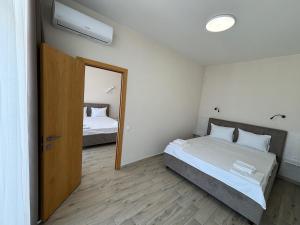 a bedroom with two beds and a mirror at Milos Hotel in Zatoka