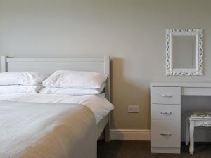 a bedroom with a bed and a dresser and a mirror at Four Dorchester Drive - Uk32042 in Inglewhite