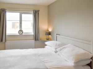 a white bed in a bedroom with a window at Four Dorchester Drive - Uk32042 in Inglewhite