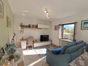 a living room with a blue couch and a table at VILLA ADRY Aosta Sarre Your freedom in Aosta