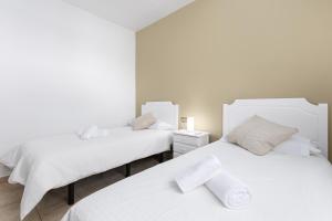 two beds in a white room with white sheets at Home2Book Luxury Villa Escape, Private Pool & BBQ in Antigua +32 photos