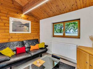 a living room with a black leather couch at Holiday Home Ferienhaus Bude 120 by Interhome in Bad Arolsen