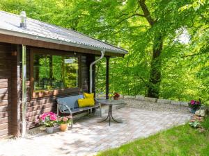 a pavilion with a table and a chair on a patio at Holiday Home Ferienhaus Bude 120 by Interhome in Bad Arolsen