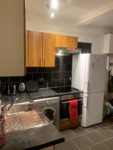una cucina con fornelli e frigorifero di The Oxford St Stay a Londra Altre 10 foto