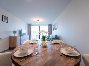 a dining room with a wooden table and chairs at Apartment Elyana with balcony by Interhome in Blankenberge