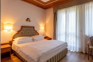 Postel nebo postele na pokoji v ubytování Hotel Sporting