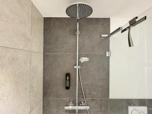 eine Dusche mit Duschkopf in einem Badezimmer in der Unterkunft Exklusives 3 Zi Design Apartment in FR-Altstadt in Freiburg im Breisgau