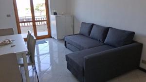 a living room with a couch and a table at Riposto Sea & Etna View Retreat in Riposto +4 photos