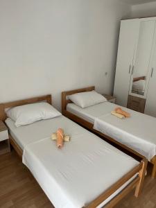 two twin beds in a room with a mirror at Apartment MJ in Čapljina