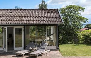 a screened in porch with chairs and a statue of a bird at Nice Home In Nykøbing Sj With Wifi in Nyrup