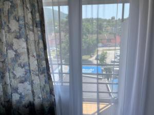a window with a view of a parking lot at Hotel Bosna in Kladanj