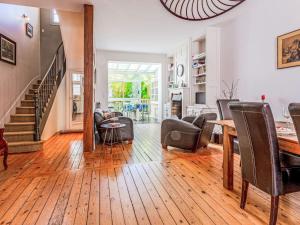a living room with a staircase and a table and chairs at Holiday Home Victor Hugo by Interhome in Deauville