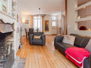 a living room with a couch and a fireplace at Holiday Home Victor Hugo by Interhome in Deauville +30 photos