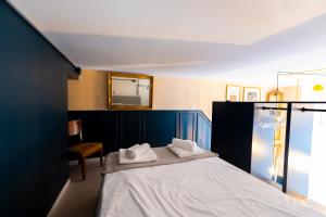 a bedroom with a bed with a mirror and a chair at Metro M1 - Stylish Loft Retreat in Sesto San Giovanni