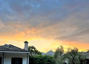 a house with a sunset in the background at Elgi Cottage in Chrysi Ammoudia +17 photos