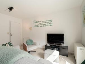 a living room with a bed and a tv at Apartment Havenhuys IV by Interhome in Bredene