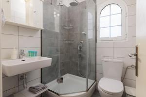 a bathroom with a shower and a toilet and a sink at Villa Caterina in Ýpsos +33 photos