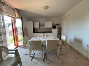 a kitchen and dining room with a table and chairs at Apartment Put Vidaka in Poličnik