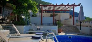 a patio with a swimming pool and a pergola at Villa Smoquizza in Smokvica +22 photos