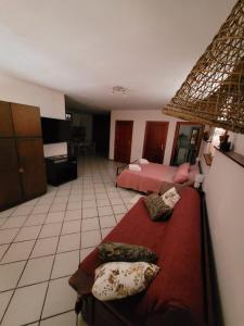 a bedroom with two beds and a red blanket at Casa Baratz in Santa Maria la Palma